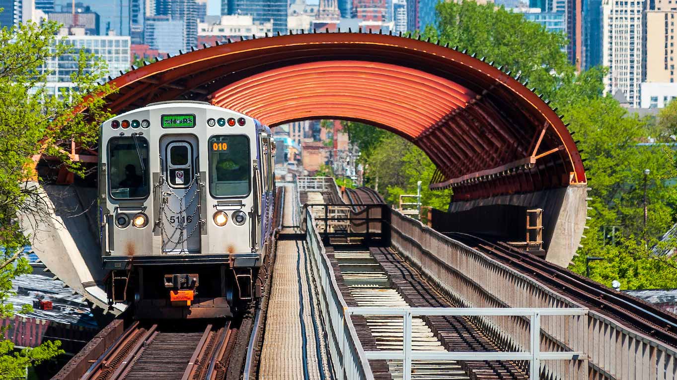 A photo of the Green Line CTA train with the Chicago skyline in the background
