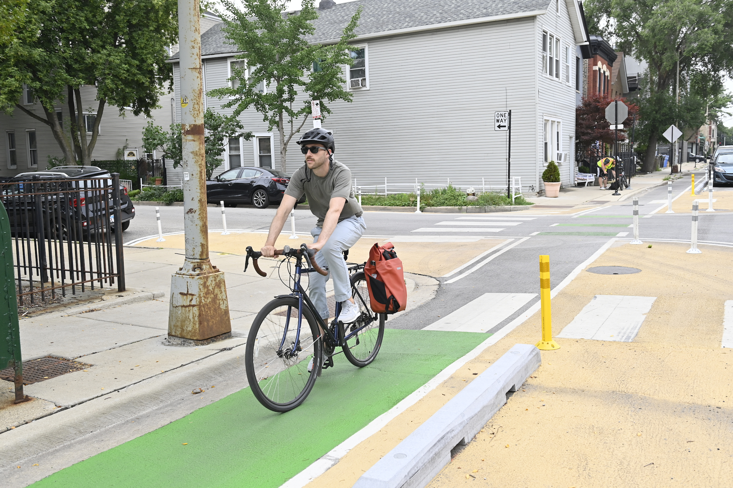 A person riding a bicycle on the new protected bike lanes on Augusta Boulevard