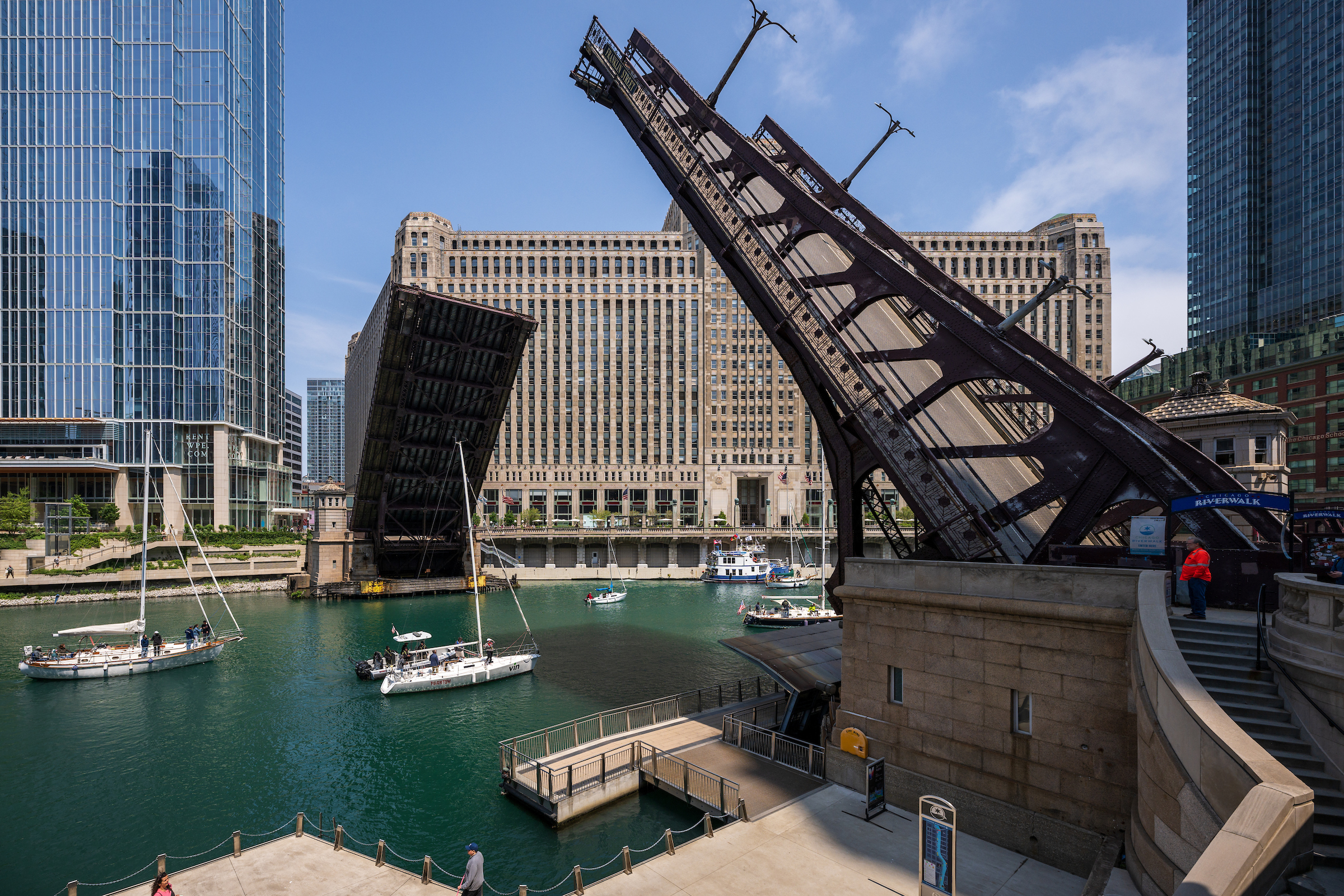 A bridge being raised to allow sailboats to pass