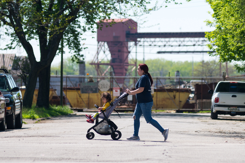 Woman pushing stroller in urban environment