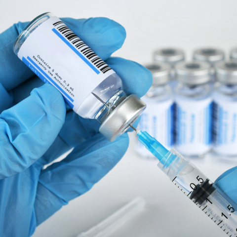 syringe drawing from vial