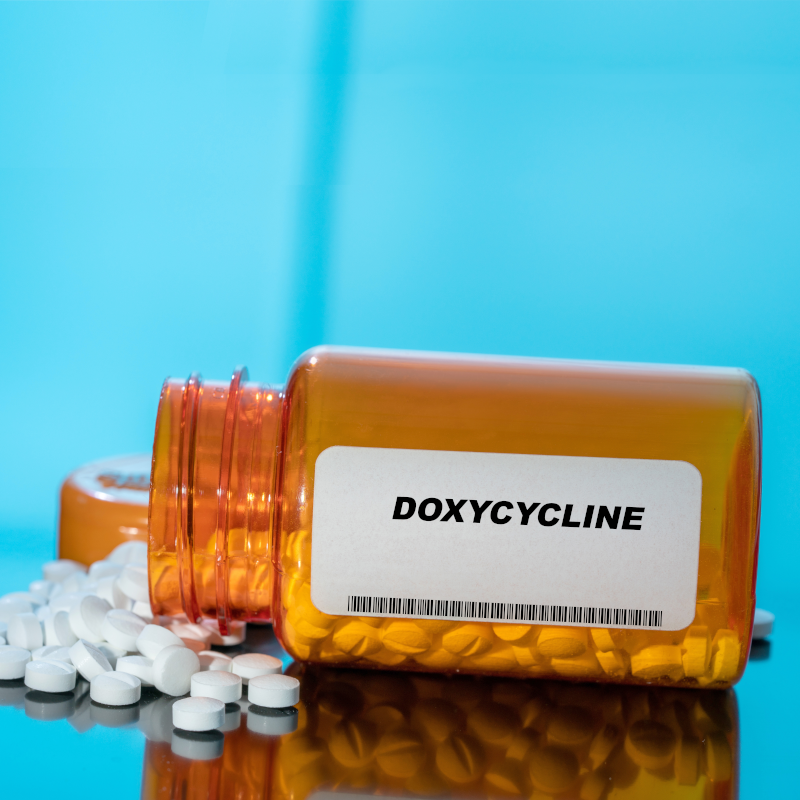 doxycycline prescription bottle with pills spilling out doxycycline prescription bottle with pills spilling out