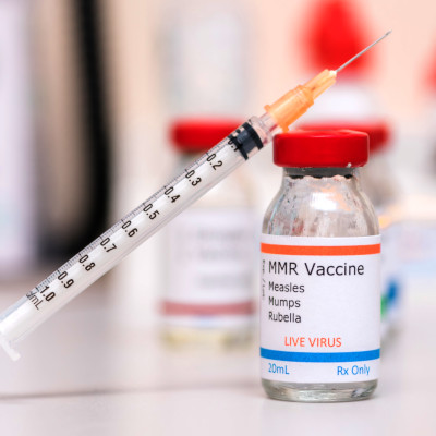 Intro Pic - MMR vaccine MMR vaccine vial with syringe resting atop it