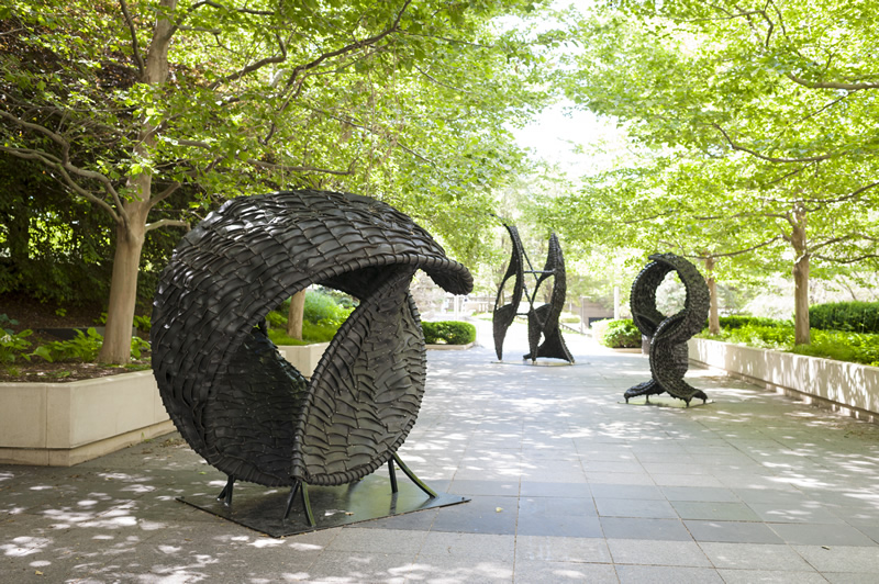 Chakaia Booker (PASS THE BUCK 2008, rubber tires & stainless steel,  96 x 96 x 96 inches)