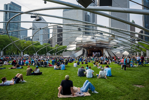 Millennium Park (Crowd sitting on lawn enjoying performance on stage)