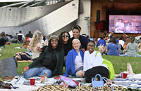Group of woman picnicking on the Great Lawn in Millennium Park during the Summer Music Series