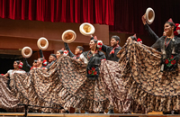 Dancers performing onstage at the Pritzker Pavilion Stage in Millennium Park