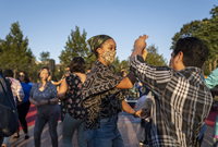 People dance at the SummerDance in the Parks series at Portage Park in Chicago's Portage Park neighborhood