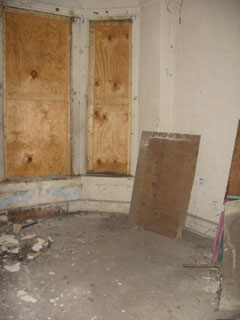 Main living room with boarded windows