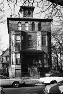 Brick house with four arched windows and brick masonry in black and white