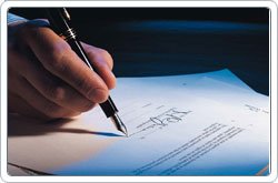 picture of hand signing a document