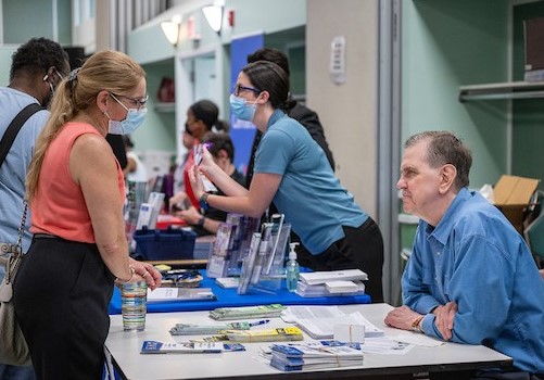 two people having a conversation at a resource fair