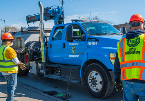 A Water Management vehicle with crew working on a sewer