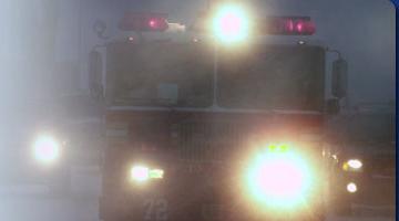 Image of fire truck driving through a blizzard