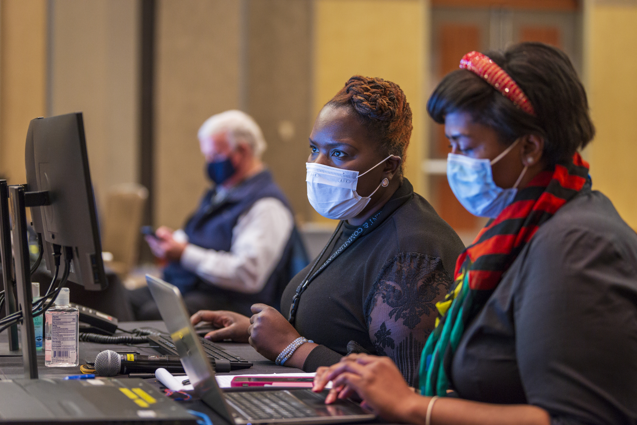 several people at terminals and laptops