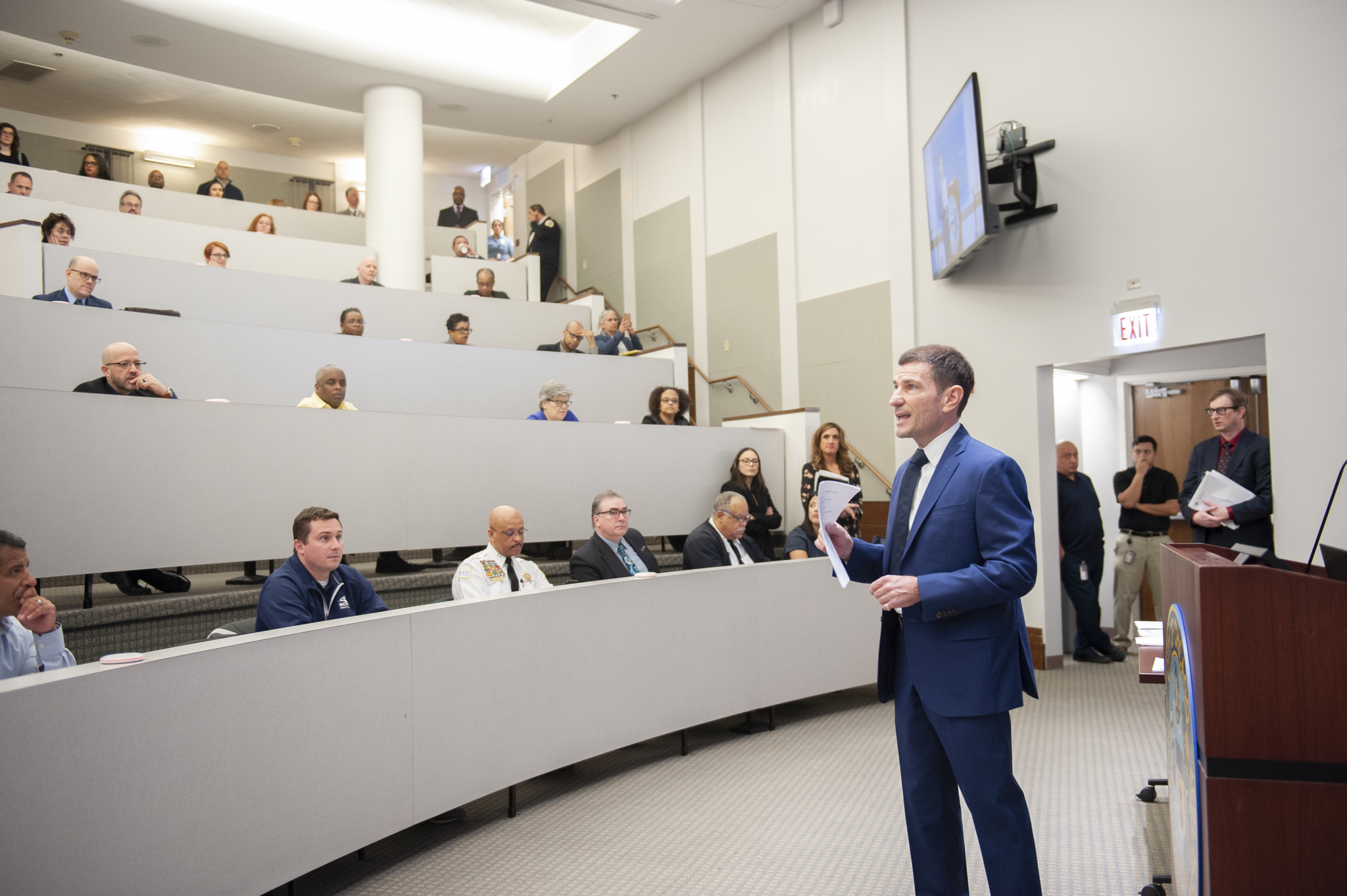 Several people in a meeting. One person is talking