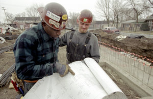 Two men looking at a plan