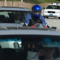 Man on a motorcycle and some cars in traffic Man on a motorcycle and some cars in traffic