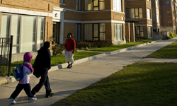 People walking in front of an apartment building