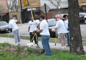 Several People Cleaning Streets with Brooms Several People Cleaning Streets with Brooms