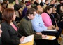 Group of people sitting taking notes