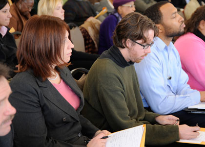 Group of people sitting taking notes