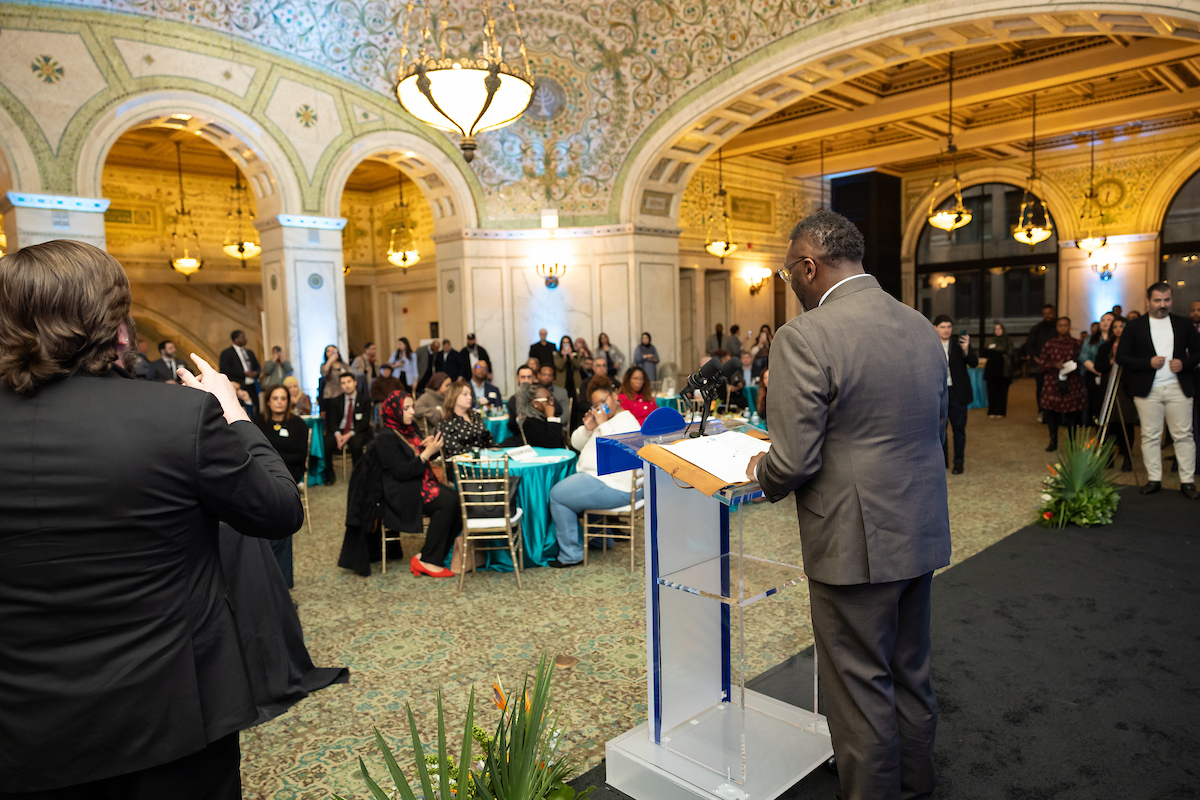 Mayor Brandon Johnson speaking before a crowd at the Arab American reception.