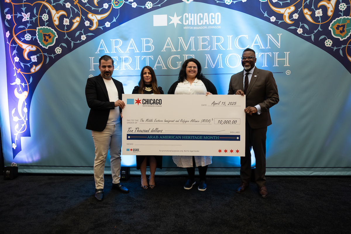 Mayor Brandon Johnson presenting a check to the Middle Eastern Immigrant and Refugee Alliance