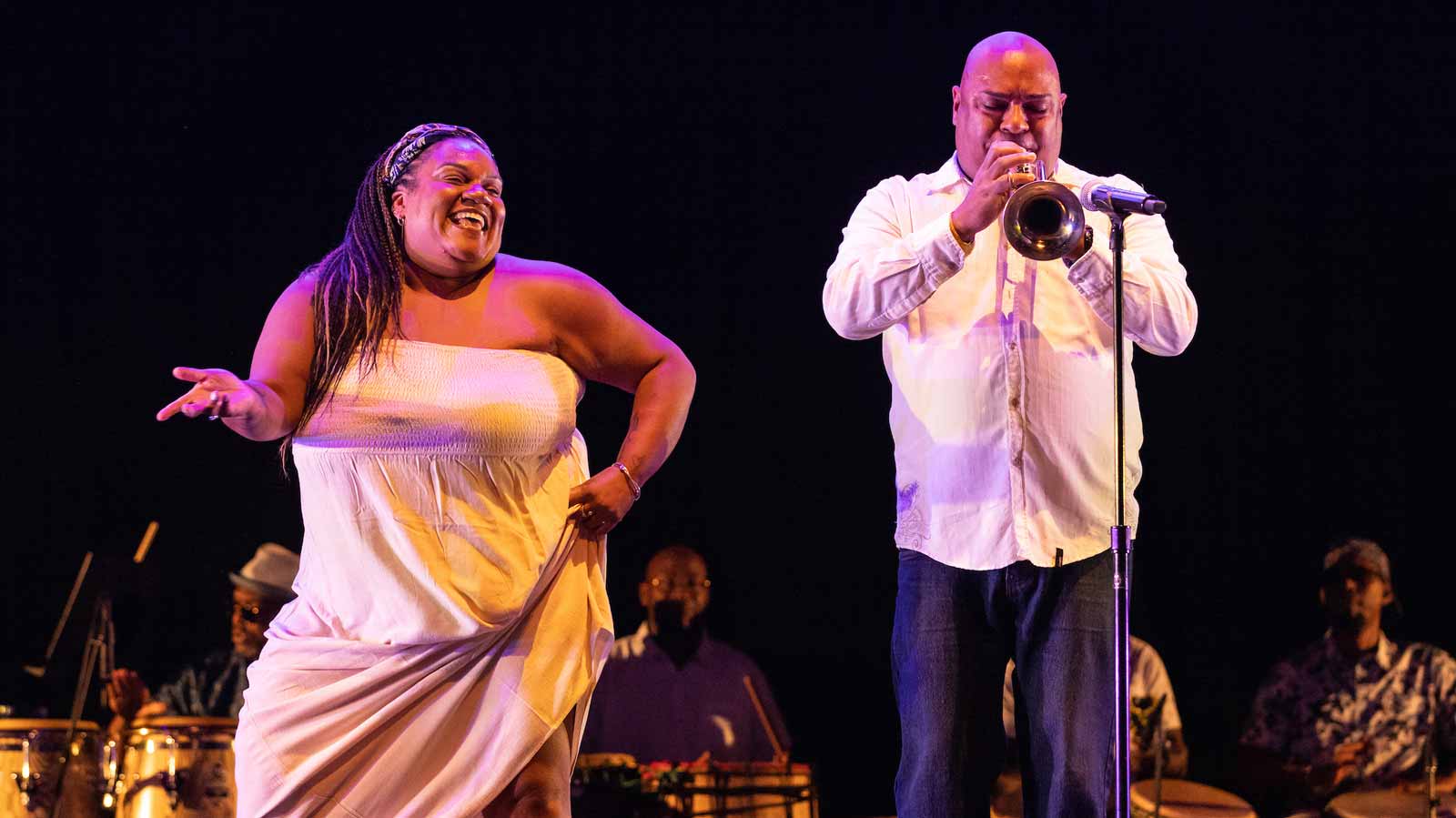 A dancer performing with a trumpet play at the Harris Theater