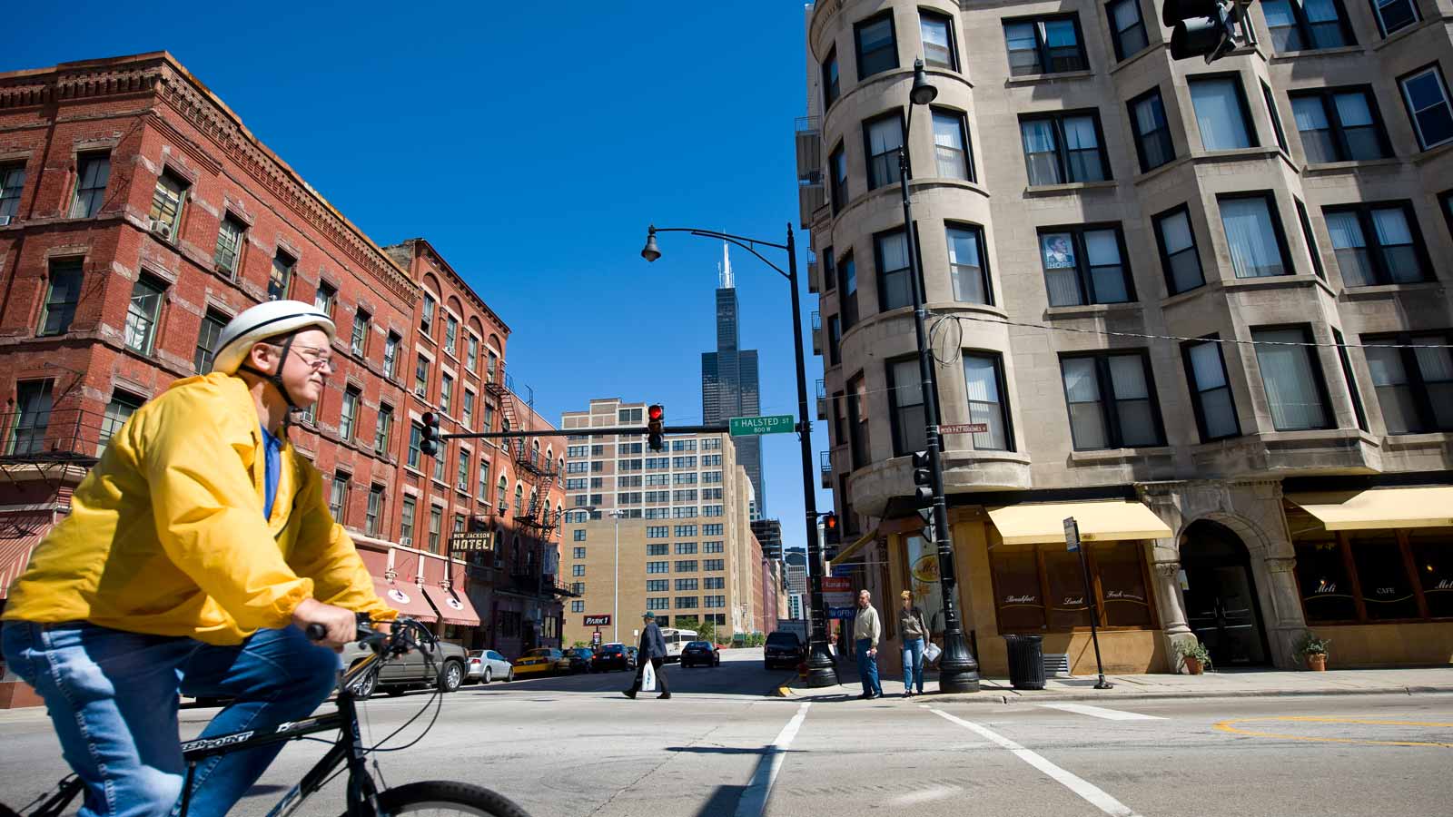 A photo of Halsted Street in Greektown with the Sears Tower in the background