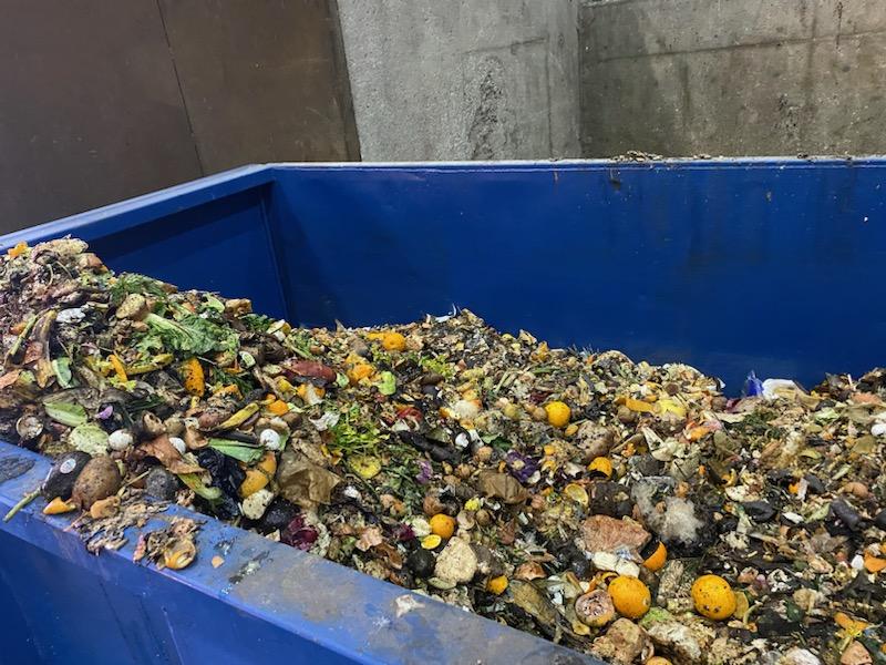 DSS crews unload the food scraps into a large roll-off container at a a city-owned transfer facility.