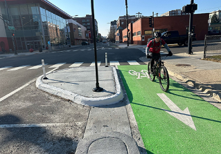 Person riding Divvy bike on street