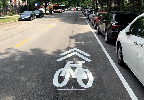 Street with bike symbol markings on the roadway