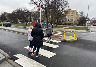 Green painted bike lane curbside with 20 mph sign 