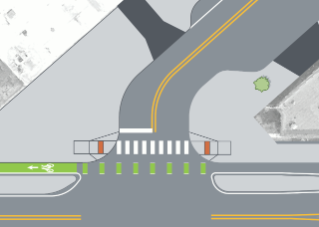 person riding bike waiting at protected intersection