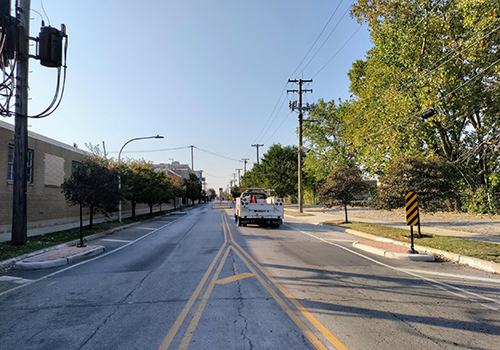 Truck driving on street with mid-block bumpouts