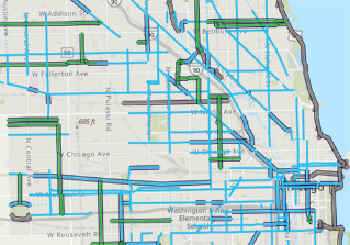 person riding bike waiting at protected intersection