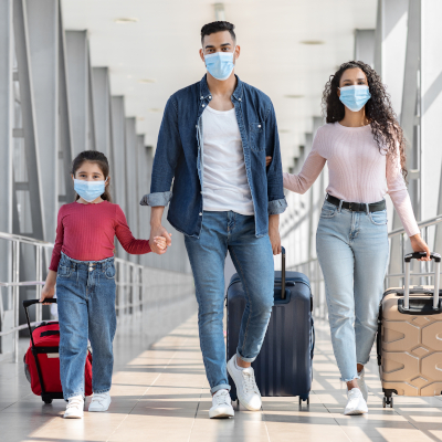 masked mother, father, and child traveling together, pulling rolling suitcases masked mother, father, and child traveling together, pulling rolling suitcases