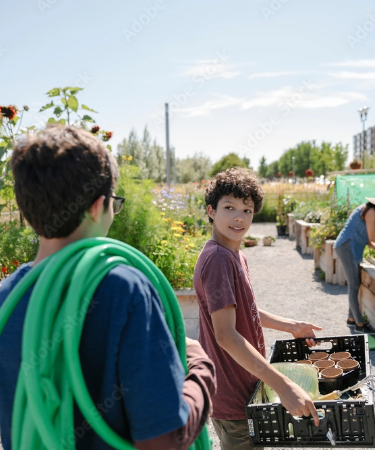 Photo of two adolescents helping in a community garden