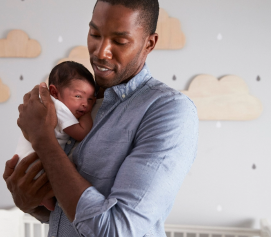 Young father holding an infant