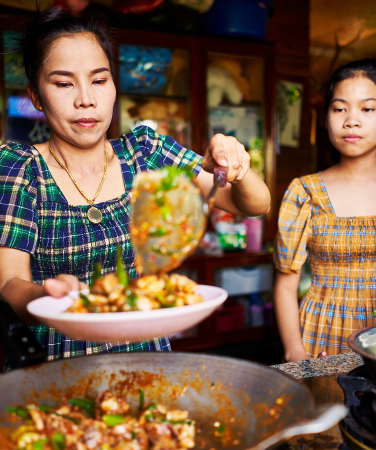 Photo of a mother and daughter making food together