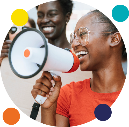 Smiling adolescent girl holding megaphone to her mouth