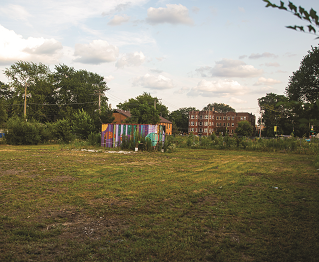 open lot with apartment building on the site