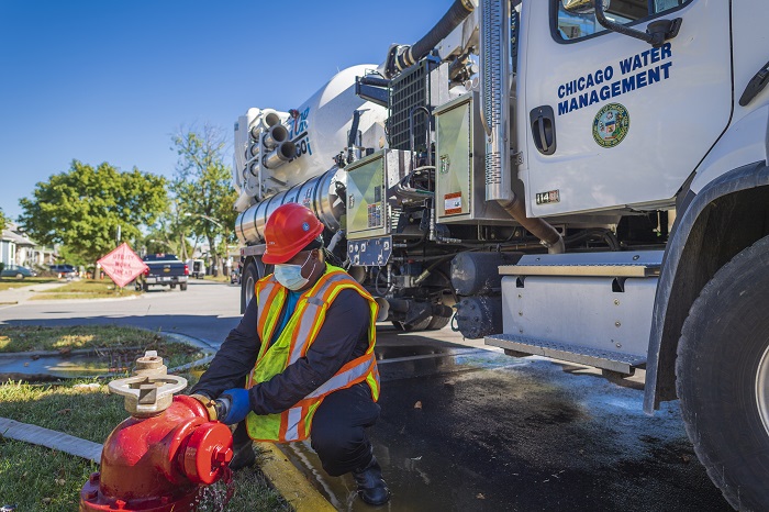 Chicago Water Management employee fixing fire hydrant