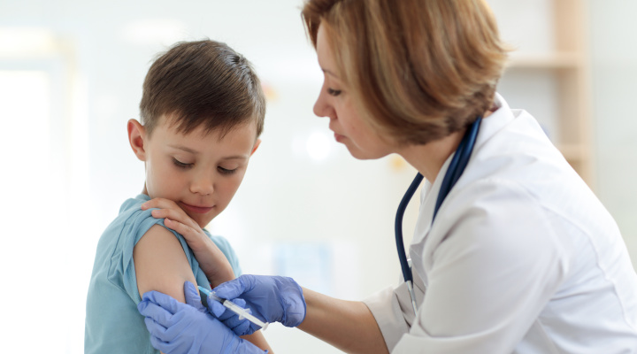 young child with pediatrician, receiving injection