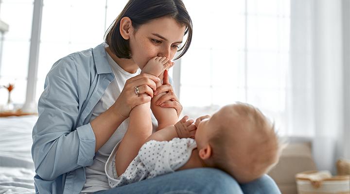 woman playing with infant in her lap