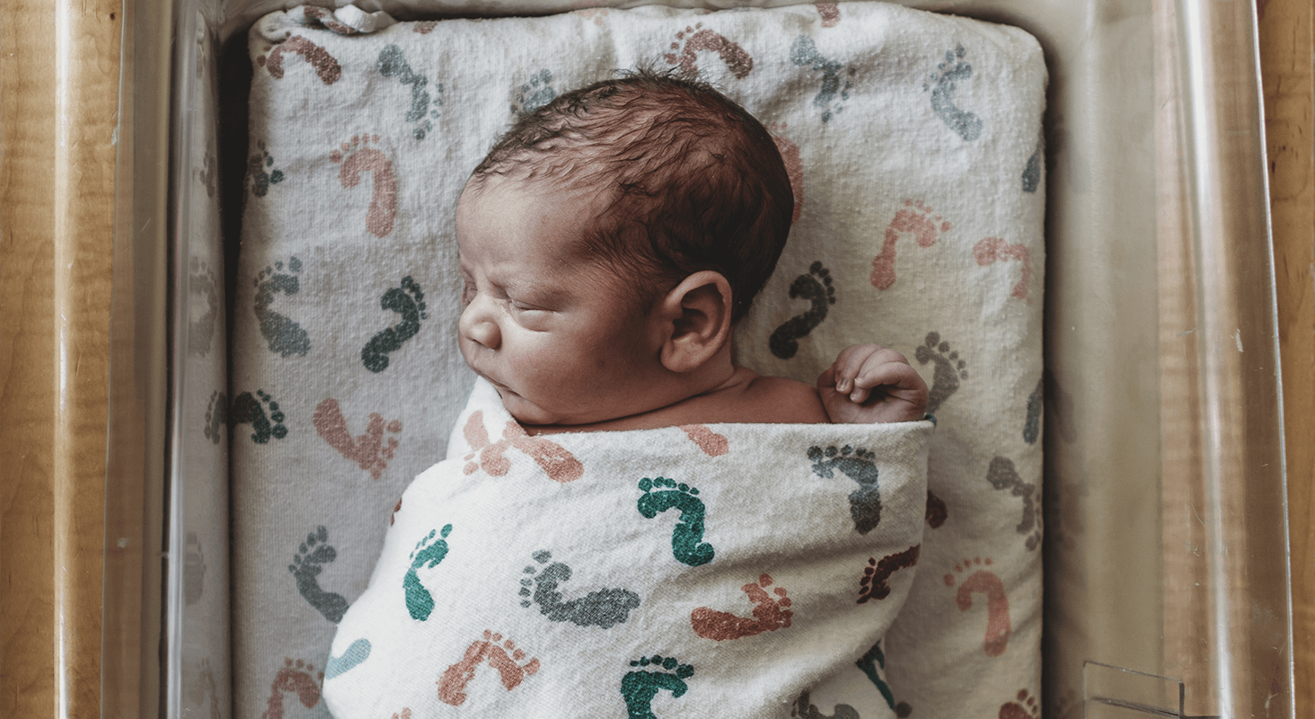 Going Home With Baby - The Newborn Nursery swaddled infant asleep in crib