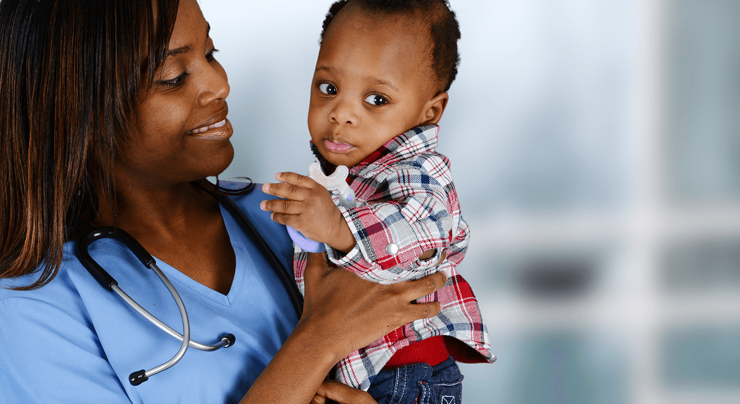 Female nurse holding infant