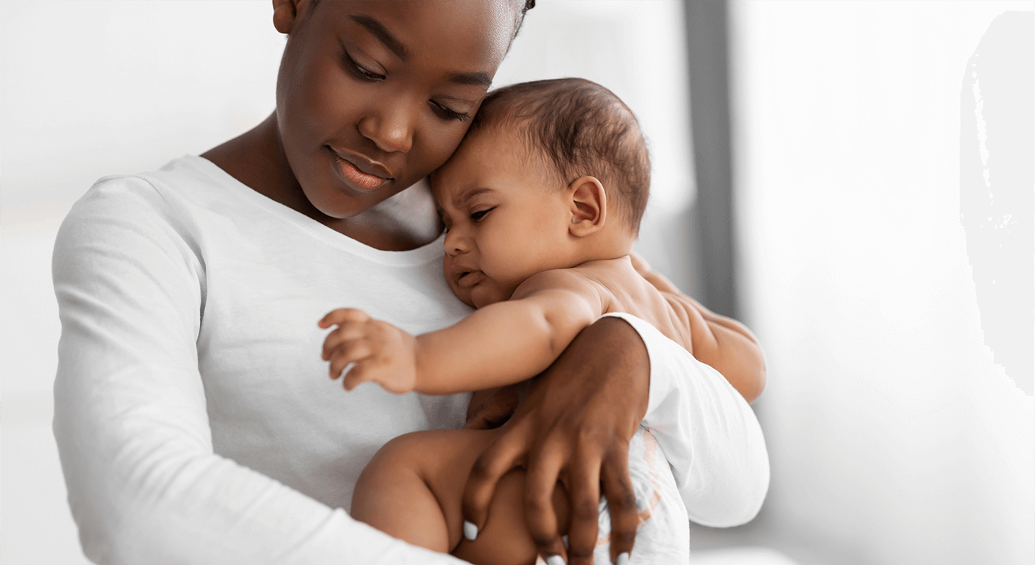 Adult female holding infant Adult female holding infant